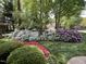 Lush garden featuring mature hedges, flowering bushes and a meticulously maintained lawn at 102 Pin Oak Ct, Elon, NC 27244