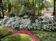 Lush garden featuring mature hedges, flowering bushes and a meticulously maintained lawn at 102 Pin Oak Ct, Elon, NC 27244