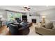 Bright living room featuring a fireplace, ceiling fan and patio access at 102 Pin Oak Ct, Elon, NC 27244