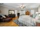 Hardwood floor primary bedroom offers a seating area and an attached en suite bathroom at 102 Pin Oak Ct, Elon, NC 27244