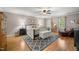 Spacious main bedroom with hardwood floors, natural light, and a cozy sitting area at 102 Pin Oak Ct, Elon, NC 27244