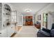 Bright office featuring built-in shelving, French doors, and a comfortable seating area at 102 Pin Oak Ct, Elon, NC 27244