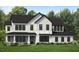 Stunning modern farmhouse with white siding, black trim, and a manicured lawn at 1025 Overdrift Ln, Cary, NC 27519