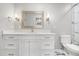 A bright bathroom featuring double sink vanity with a marble countertop and sleek, modern gold fixtures at 1061 Wirewood Dr # 303, Raleigh, NC 27605