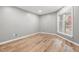 A simple yet cozy bedroom featuring hardwood floors and large windows at 1061 Wirewood Dr # 303, Raleigh, NC 27605