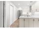 Updated kitchen boasts white cabinetry, stainless steel appliances, quartz countertops, and a convenient layout at 1061 Wirewood Dr # 303, Raleigh, NC 27605