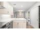 Open-concept kitchen with island, stainless appliances, and white cabinetry creating a modern and functional space at 1061 Wirewood Dr # 303, Raleigh, NC 27605