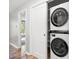 Convenient laundry area featuring a stacked washer and dryer, maximizing space and efficiency at 1061 Wirewood Dr # 303, Raleigh, NC 27605