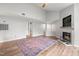 Spacious living room with hardwood floors, fireplace, vaulted ceiling, and access to other rooms at 1061 Wirewood Dr # 303, Raleigh, NC 27605
