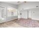 A bright living room featuring hardwood floors, a ceiling fan, access to a kitchen, and recessed lighting at 1061 Wirewood Dr # 303, Raleigh, NC 27605