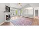 Bright living room with hardwood floors, a modern fireplace, vaulted ceilings, and large windows at 1061 Wirewood Dr # 303, Raleigh, NC 27605