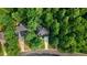 Overhead shot of a home with dark roof surrounded by green trees on a peaceful street at 1128 Neuse Ridge Dr, Clayton, NC 27527