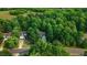 Aerial view of a light blue home nestled among lush green trees in a quiet neighborhood at 1128 Neuse Ridge Dr, Clayton, NC 27527