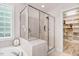 Bathroom featuring a glass shower and a large soaking tub at 1128 Neuse Ridge Dr, Clayton, NC 27527
