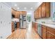 Bright kitchen with stainless appliances, wooden cabinets, and hardwood floors at 1128 Neuse Ridge Dr, Clayton, NC 27527