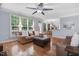 Spacious living room featuring hardwood floors, ample natural light, and a cozy seating area at 1128 Neuse Ridge Dr, Clayton, NC 27527
