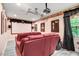 Home theater featuring plush red seating, a large screen, and decorative details for an immersive experience at 1128 Neuse Ridge Dr, Clayton, NC 27527