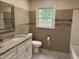Bathroom featuring granite countertop, tile, and natural light at 1208 Hatch Rd, Chapel Hill, NC 27516