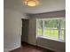 Bright bedroom featuring new paint, a large window, and wood-look flooring at 1208 Hatch Rd, Chapel Hill, NC 27516