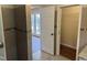 Hallway with tiled flooring leading to a closet and sunroom at 1208 Hatch Rd, Chapel Hill, NC 27516