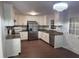 Modern kitchen featuring white cabinets, stainless steel appliances, and elegant granite countertops at 1208 Hatch Rd, Chapel Hill, NC 27516