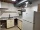 A kitchenette with a sink, granite countertops, and a white refrigerator at 1208 Hatch Rd, Chapel Hill, NC 27516