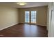 A living room featuring new paint, wood-look flooring, and glass doors to backyard at 1208 Hatch Rd, Chapel Hill, NC 27516