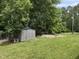 View of a metal shed in a well-maintained backyard with lush greenery at 1208 Hatch Rd, Chapel Hill, NC 27516