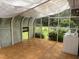 Sunroom with wood flooring, washer, and beautiful backyard view at 1208 Hatch Rd, Chapel Hill, NC 27516