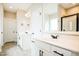 Bright bathroom featuring double sinks, granite counters, and white cabinets at 123 Pleasant View Ln, Benson, NC 27504