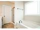 Bright bathroom featuring a soaking tub and black framed glass shower at 123 Pleasant View Ln, Benson, NC 27504