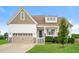 Charming two-story home with a two-car garage, inviting front porch, and manicured lawn showcasing curb appeal at 123 Pleasant View Ln, Benson, NC 27504