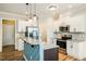 Modern kitchen featuring stainless steel appliances, granite countertops, and a stylish breakfast bar with pendant lighting at 123 Pleasant View Ln, Benson, NC 27504