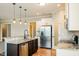 Kitchen with stainless steel appliances, granite counters, breakfast bar with pendant lights and eat in dining area at 123 Pleasant View Ln, Benson, NC 27504