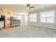 Bright living room with carpet floors, lots of natural light, and an open floor plan leading to the kitchen at 123 Pleasant View Ln, Benson, NC 27504