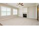 Cozy living room featuring a fireplace, built-in bookshelves, and carpet floors providing a comfortable living space at 123 Pleasant View Ln, Benson, NC 27504