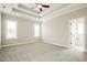 Large, carpeted main bedroom with tray ceiling and ensuite bathroom providing a private space for relaxation at 123 Pleasant View Ln, Benson, NC 27504