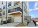 Modern townhome featuring a private balcony, garage, and grey-painted brick exterior at 138 N White St # 100, Wake Forest, NC 27587