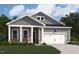 Charming home featuring a welcoming front porch, a two-car garage, and a beautifully landscaped lawn at 139 W Crescent Mills Blvd # Homesite 235, Wilson's Mills, NC 27520