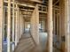 Interior framing of a new construction home with electrical wiring ready for customization and finishing touches at 139 W Crescent Mills Blvd # Homesite 235, Wilson's Mills, NC 27520
