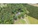Aerial view of home nestled amongst dense trees, featuring the house, outbuildings, and a winding driveway at 1401 Berea Rd, Rougemont, NC 27572