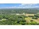 Expansive aerial view of the property featuring lush greenery, scattered ponds and trees at 1401 Berea Rd, Rougemont, NC 27572