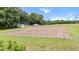 Aerial view showcasing a cleared land with a tractor trailer and small structure, bordered by trees at 1401 Berea Rd, Rougemont, NC 27572