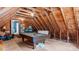 Attic space with unfinished wooden walls and ceiling beams; pool table included at 1401 Berea Rd, Rougemont, NC 27572