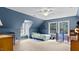 Cozy blue bedroom with carpeted floors, large windows, and sloped ceilings at 1401 Berea Rd, Rougemont, NC 27572