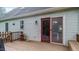 This deck features siding on the home and a cat near the sliding door at 1401 Berea Rd, Rougemont, NC 27572
