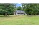 Charming home with a brick chimney and welcoming front porch surrounded by mature trees at 1401 Berea Rd, Rougemont, NC 27572