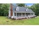 Charming home with a inviting front porch and brick chimney, set on a well-maintained lawn at 1401 Berea Rd, Rougemont, NC 27572