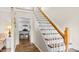 Open foyer with hardwood floors, staircase, and view into the kitchen at 1401 Berea Rd, Rougemont, NC 27572