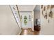 Inviting foyer with hardwood floors, staircase, and natural light coming through the door at 1401 Berea Rd, Rougemont, NC 27572
